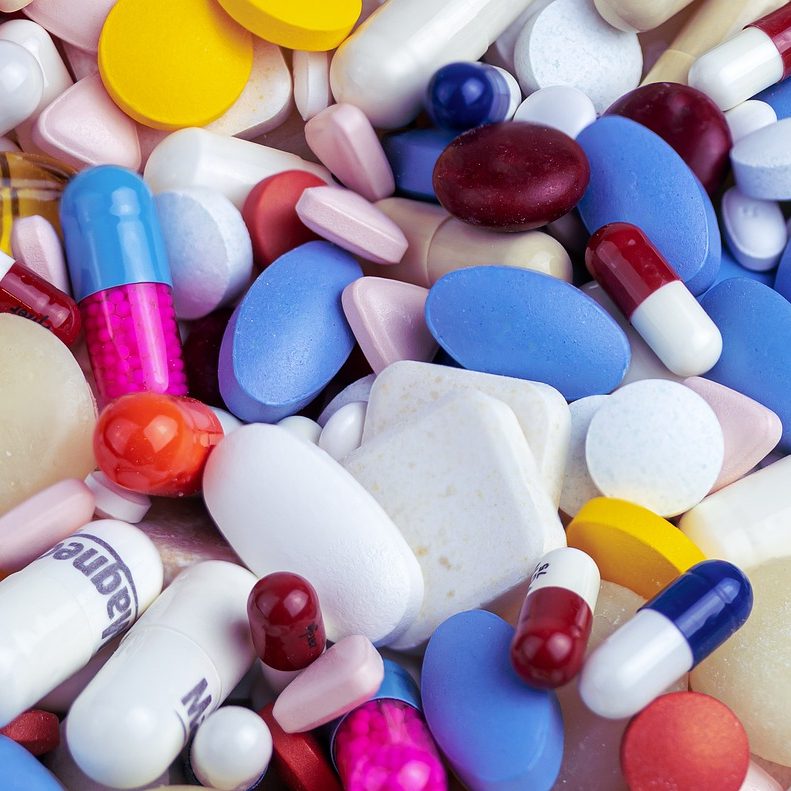 Multi-colored pills in various shapes an sizes.
